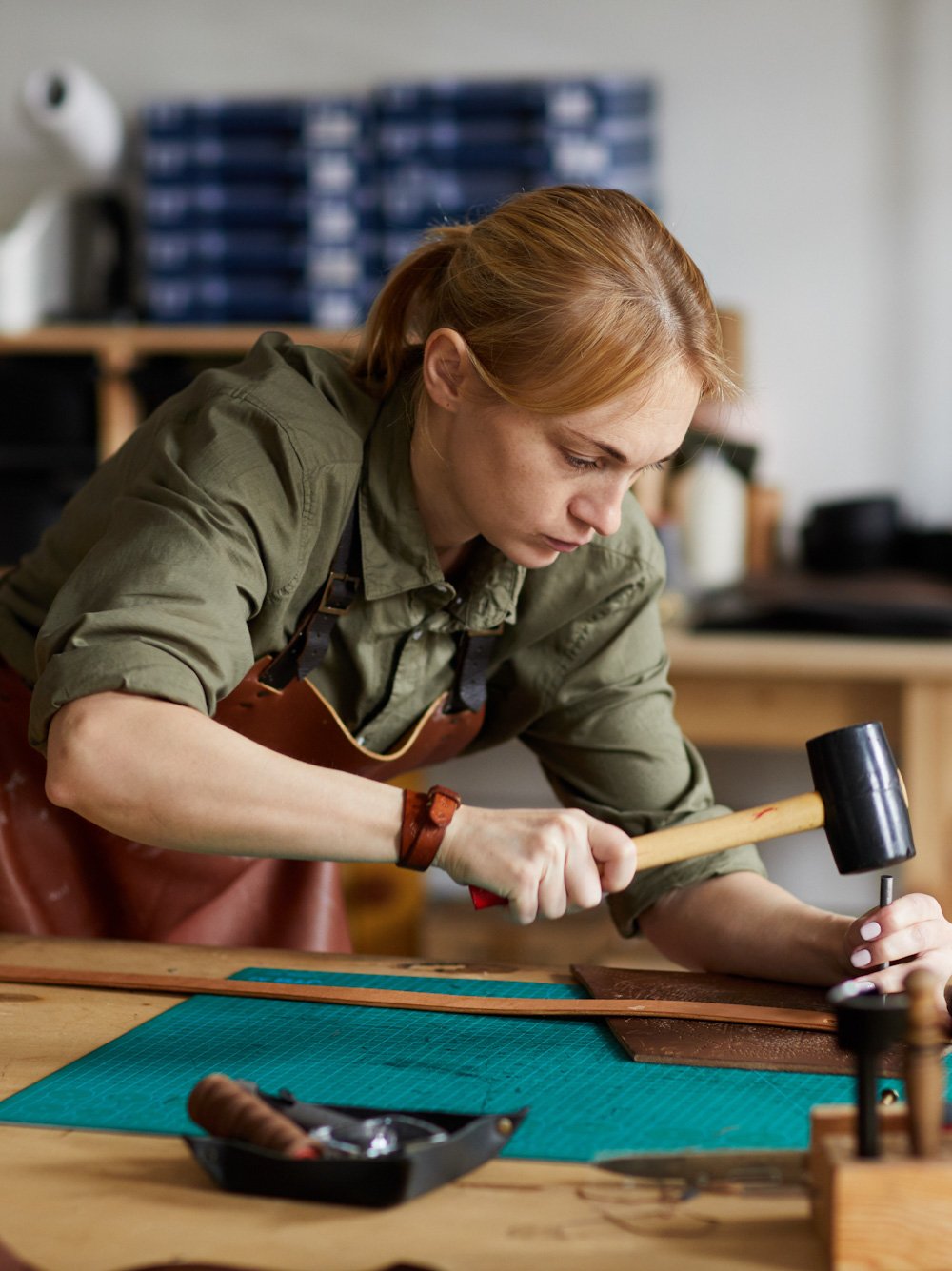 Student doing leatherwork at a school